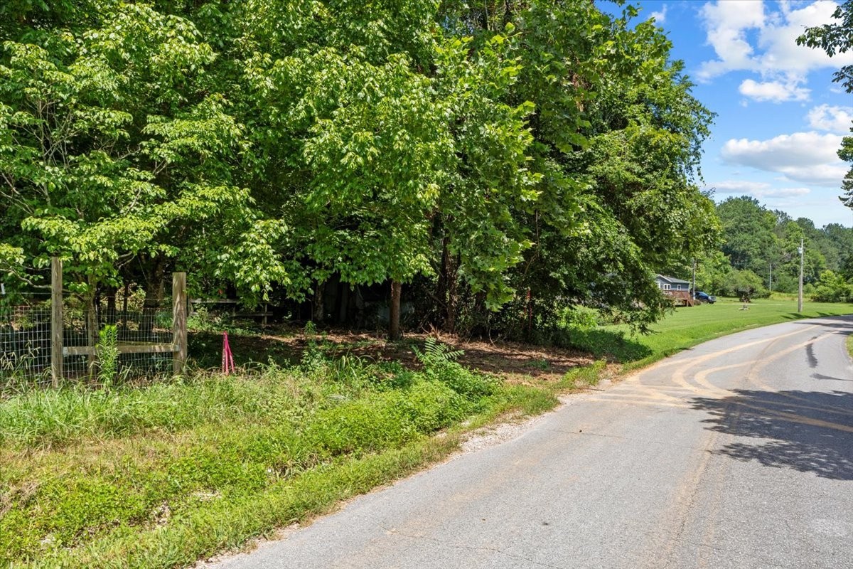 0 Upper Creek Road Vanleer, TN 37181 - Photo 2 of 24 a backyard of a house with lots of green space and fountain in the back