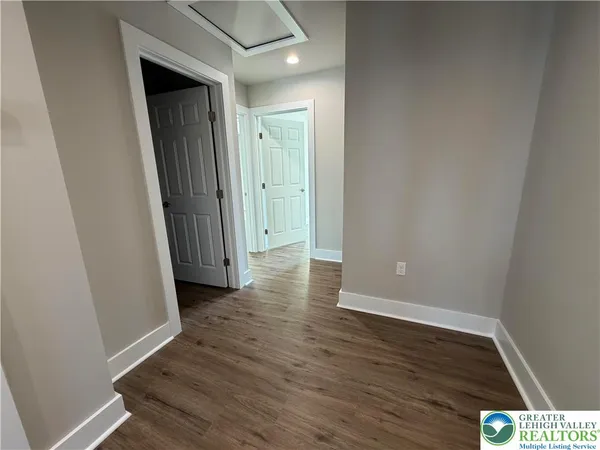 a view of a hallway with wooden floor