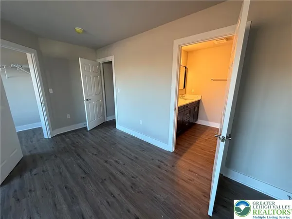 a view of hallway with wooden floor and stairs