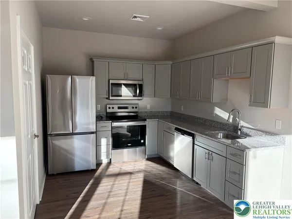 a kitchen with a refrigerator a sink and a stove