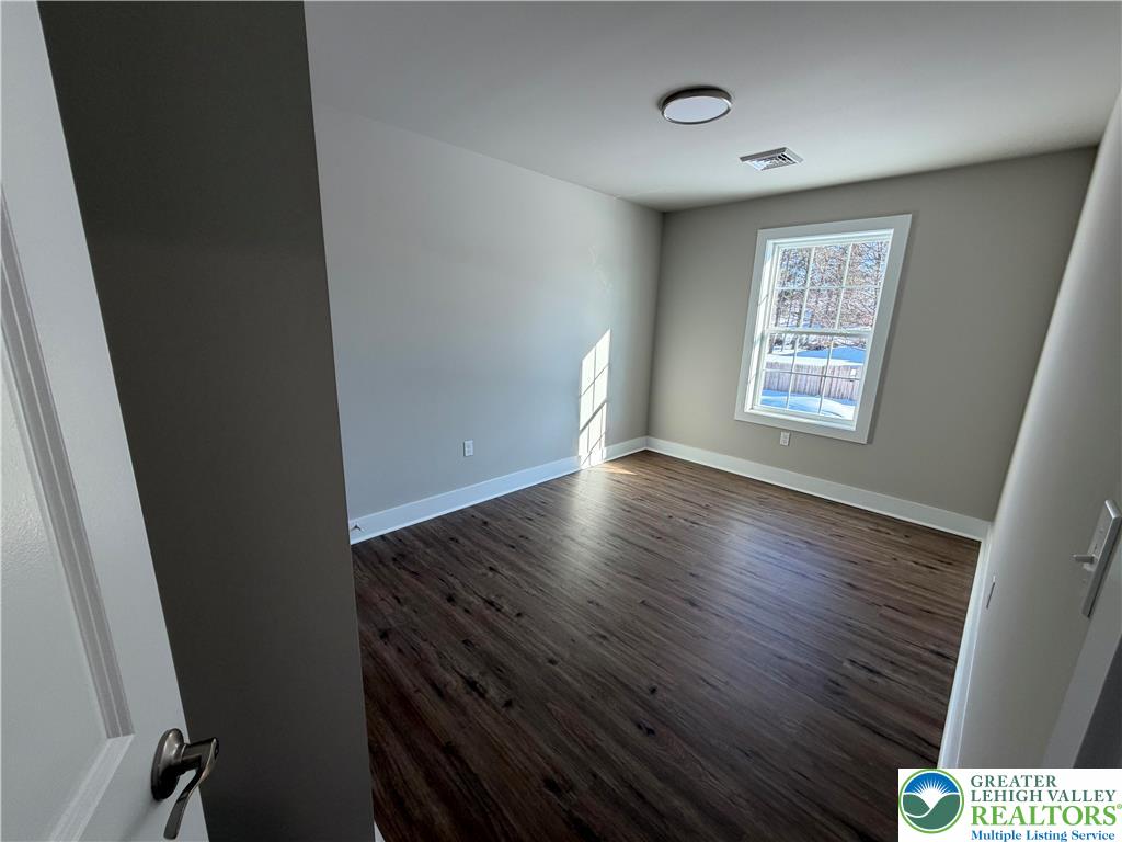 1747 Williams Street, Unit B Hellertown, PA 18055 - Photo 6 of 10 a view of an empty room with wooden floor and a window