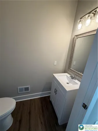 a bathroom with a sink toilet and vanity