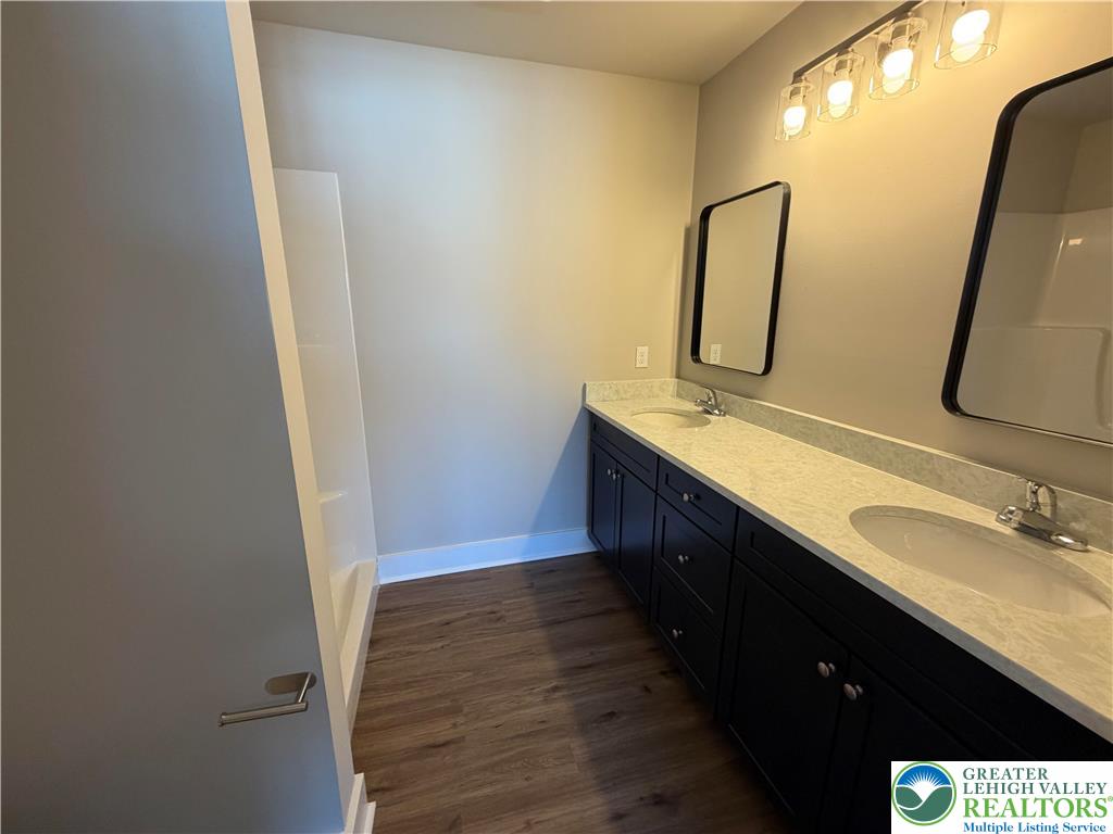 1747 Williams Street, Unit B Hellertown, PA 18055 - Photo 10 of 10 a bathroom with a double vanity sink and mirror