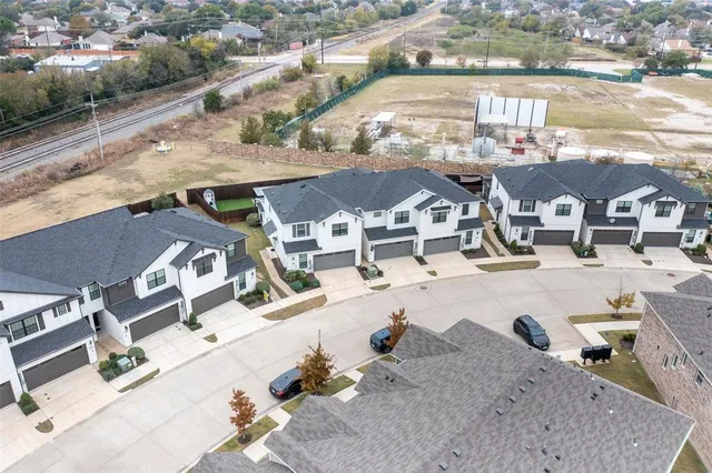 an aerial view of a house with a backyard