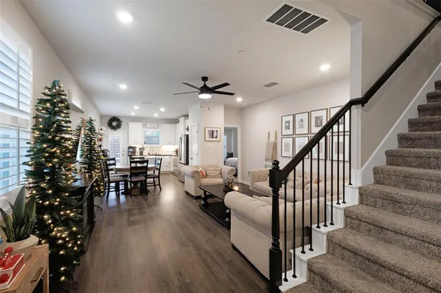 a living room with furniture or wooden floor potted plant and a window