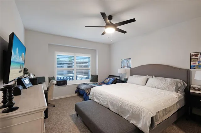 a bedroom with a large bed and a flat screen tv