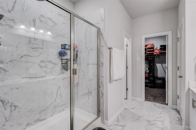 a bathroom with a shower and a glass door
