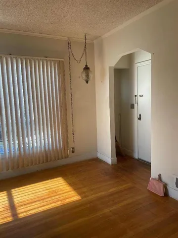 a view of room with window and hardwood floor
