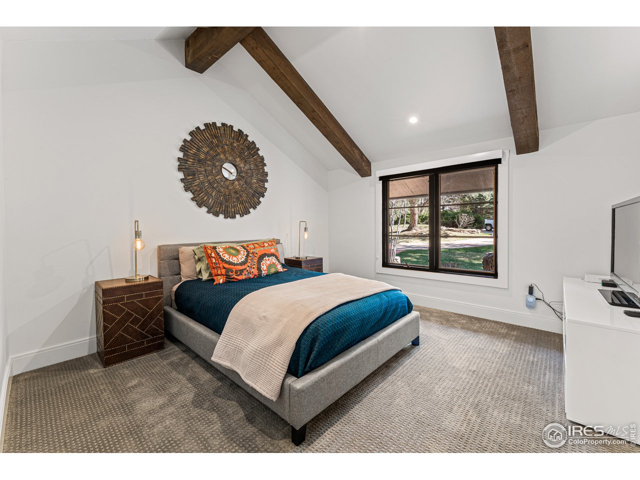 7126 Four Rivers Road Boulder, CO 80301 - Photo 16 of 38 a bedroom with a bed and a large window