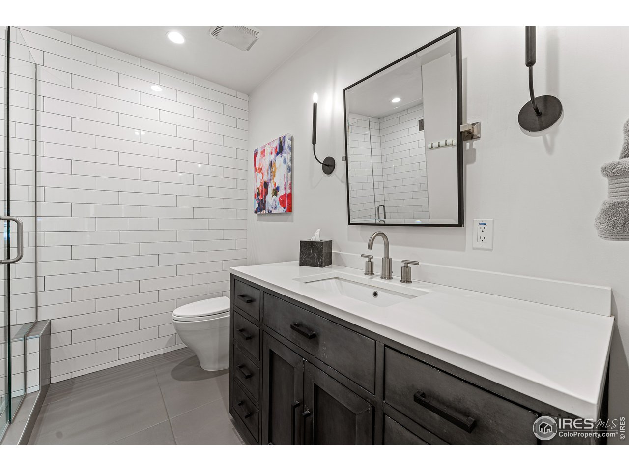 7126 Four Rivers Road Boulder, CO 80301 - Photo 17 of 38 a bathroom with a sink mirror toilet and shower