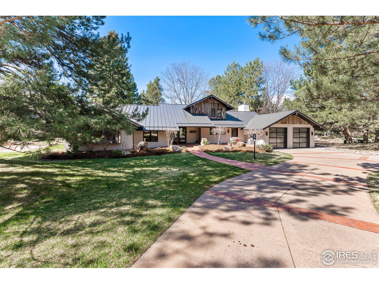 7126 Four Rivers Road Boulder, CO 80301 - Photo 2 of 38 a front view of a house with a yard