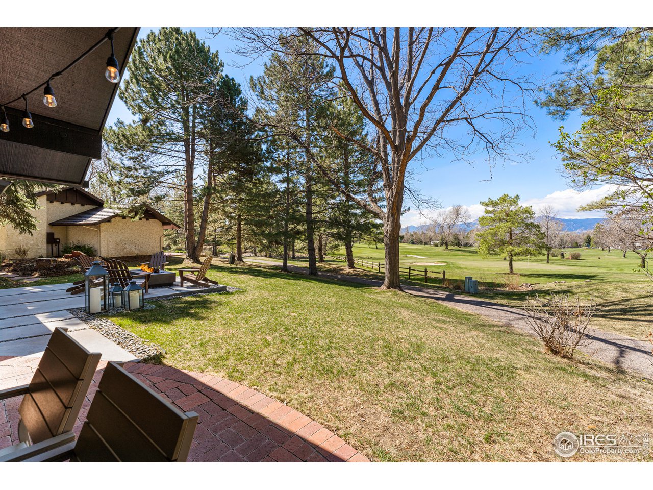 7126 Four Rivers Road Boulder, CO 80301 - Photo 32 of 38 a view of swimming pool with outdoor seating and trees in the background