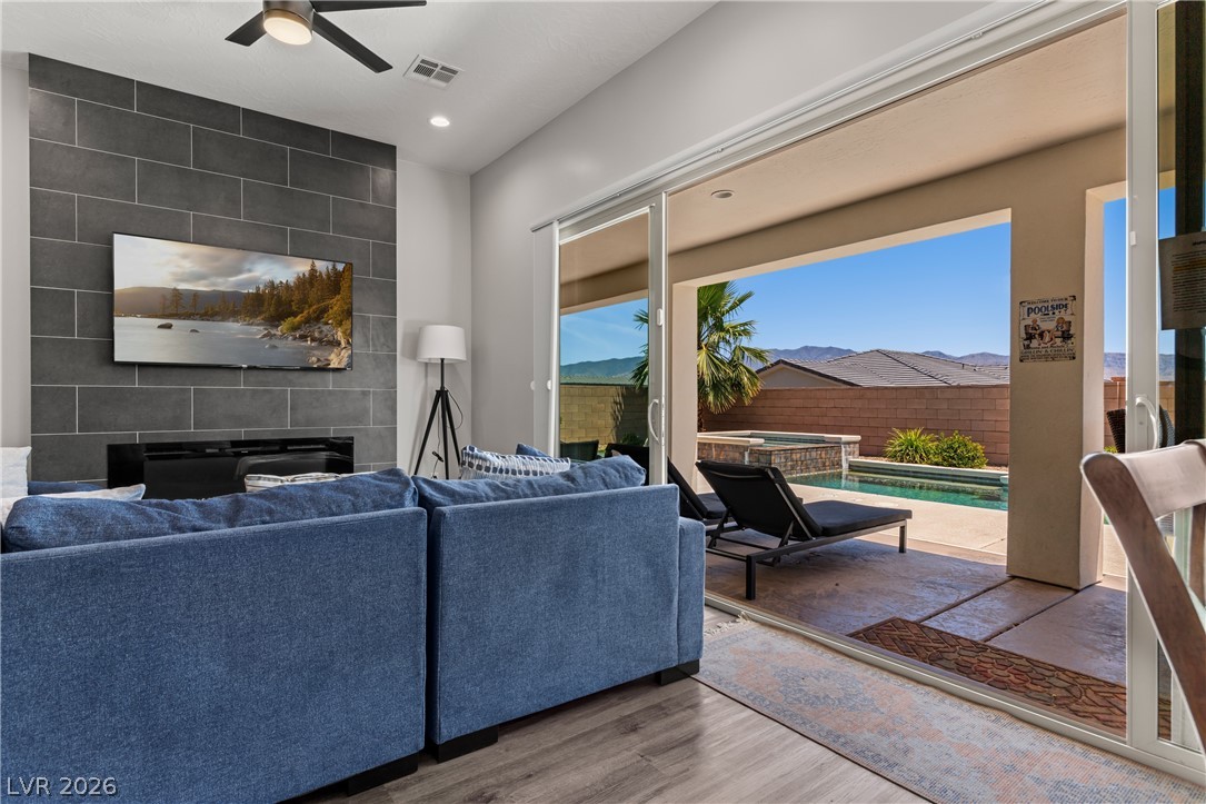 1436 Manassas Ridge Mesquite, NV 89027 - Photo 43 of 77 Floor-to-ceiling sliding glass doors unveil a private oasis with a sparkling pool and spa.
