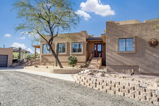 a view of a house with a yard covered in snow