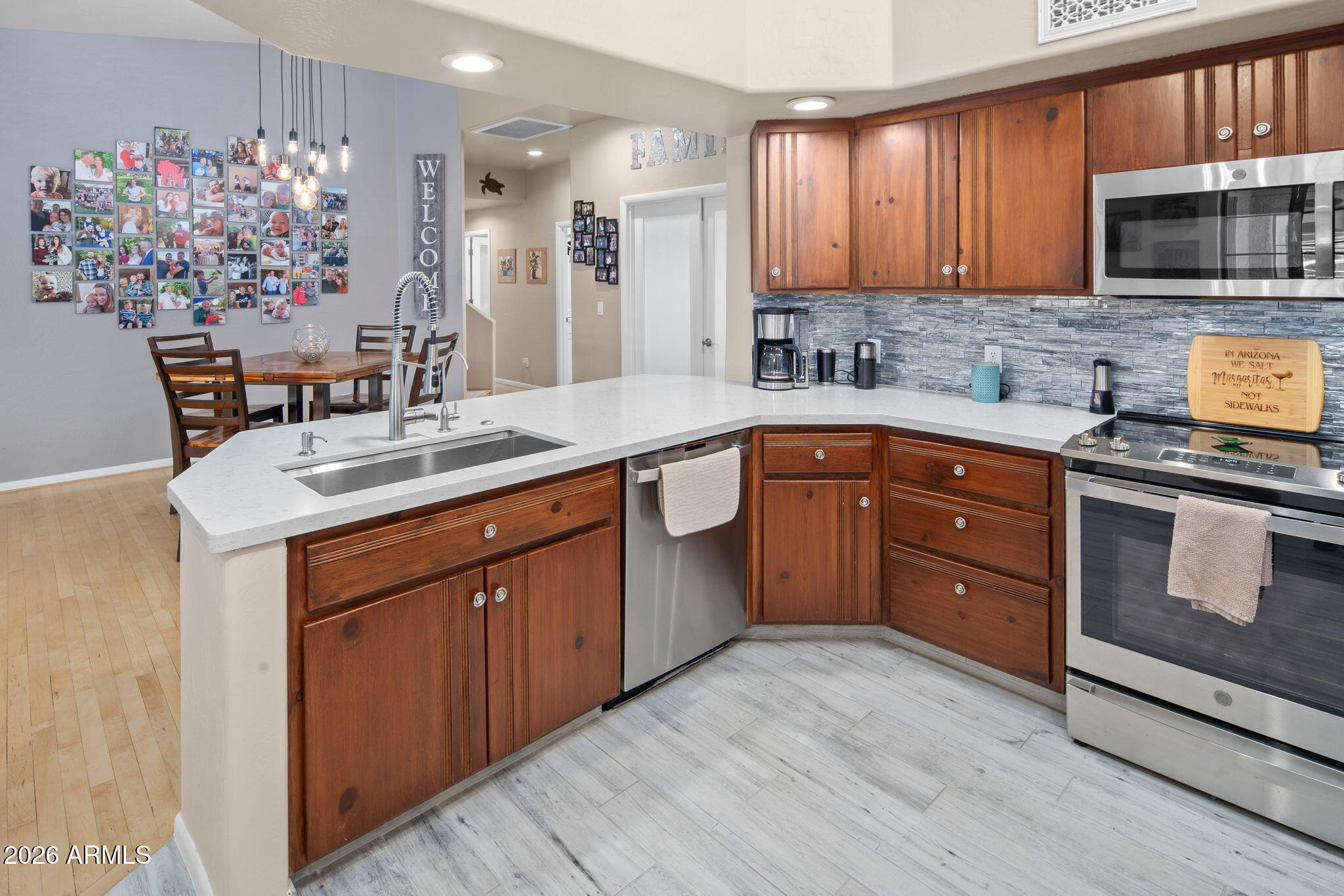 42331 North 3rd Street Phoenix, AZ 85086 - Photo 12 of 52 a kitchen with stainless steel appliances granite countertop a sink stove and microwave
