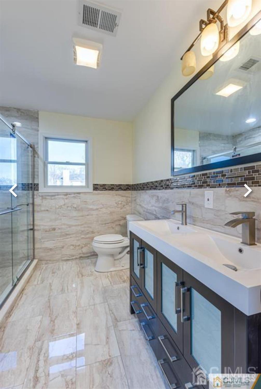 19 Henry Street Edison, NJ 08820 - Photo 12 of 33 a bathroom with a sink and a mirror