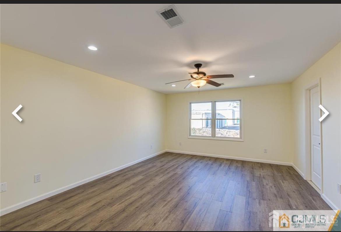19 Henry Street Edison, NJ 08820 - Photo 15 of 33 a view of an empty room with wooden floor and a window