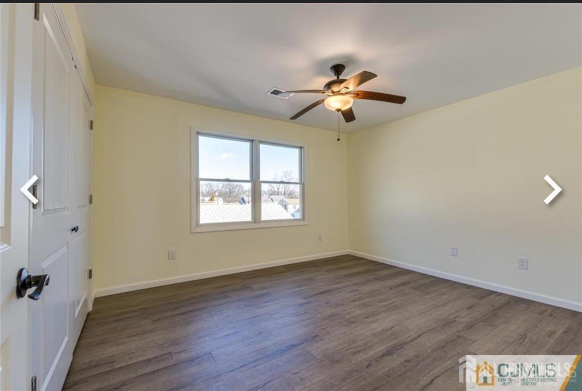 19 Henry Street Edison, NJ 08820 - Photo 18 of 33 an empty room with wooden floor fan and windows
