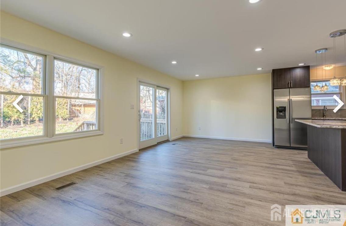 19 Henry Street Edison, NJ 08820 - Photo 22 of 33 a view of an empty room with wooden floor and a window