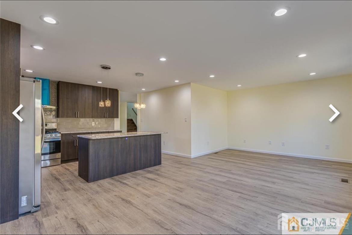 19 Henry Street Edison, NJ 08820 - Photo 23 of 33 a view of kitchen with kitchen island a sink wooden floor and a counter top space