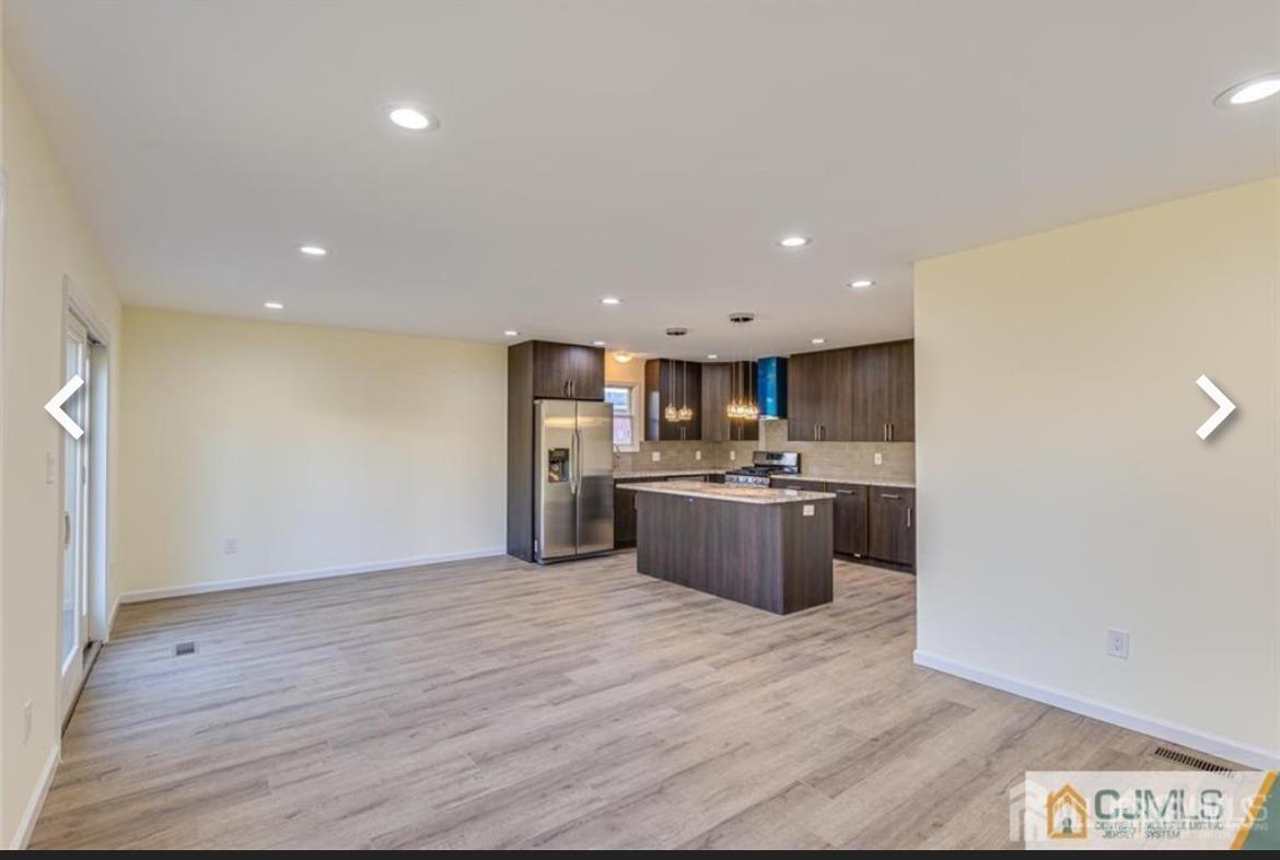 19 Henry Street Edison, NJ 08820 - Photo 26 of 33 a large kitchen with a wooden floor and a large window