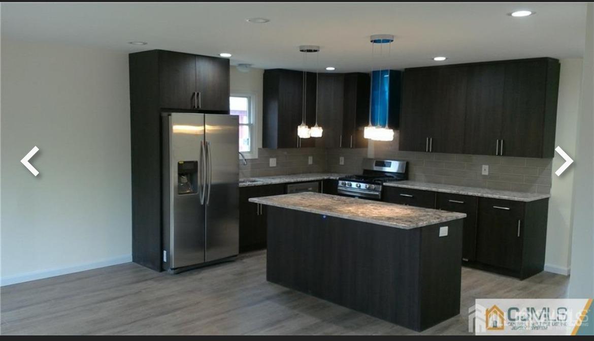 19 Henry Street Edison, NJ 08820 - Photo 27 of 33 a kitchen with stainless steel appliances granite countertop a sink a counter space and cabinets