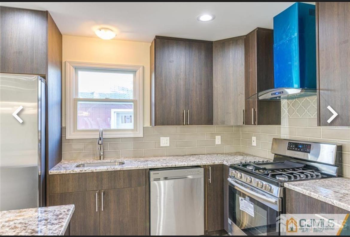 19 Henry Street Edison, NJ 08820 - Photo 29 of 33 a kitchen with granite countertop a sink stove and cabinets
