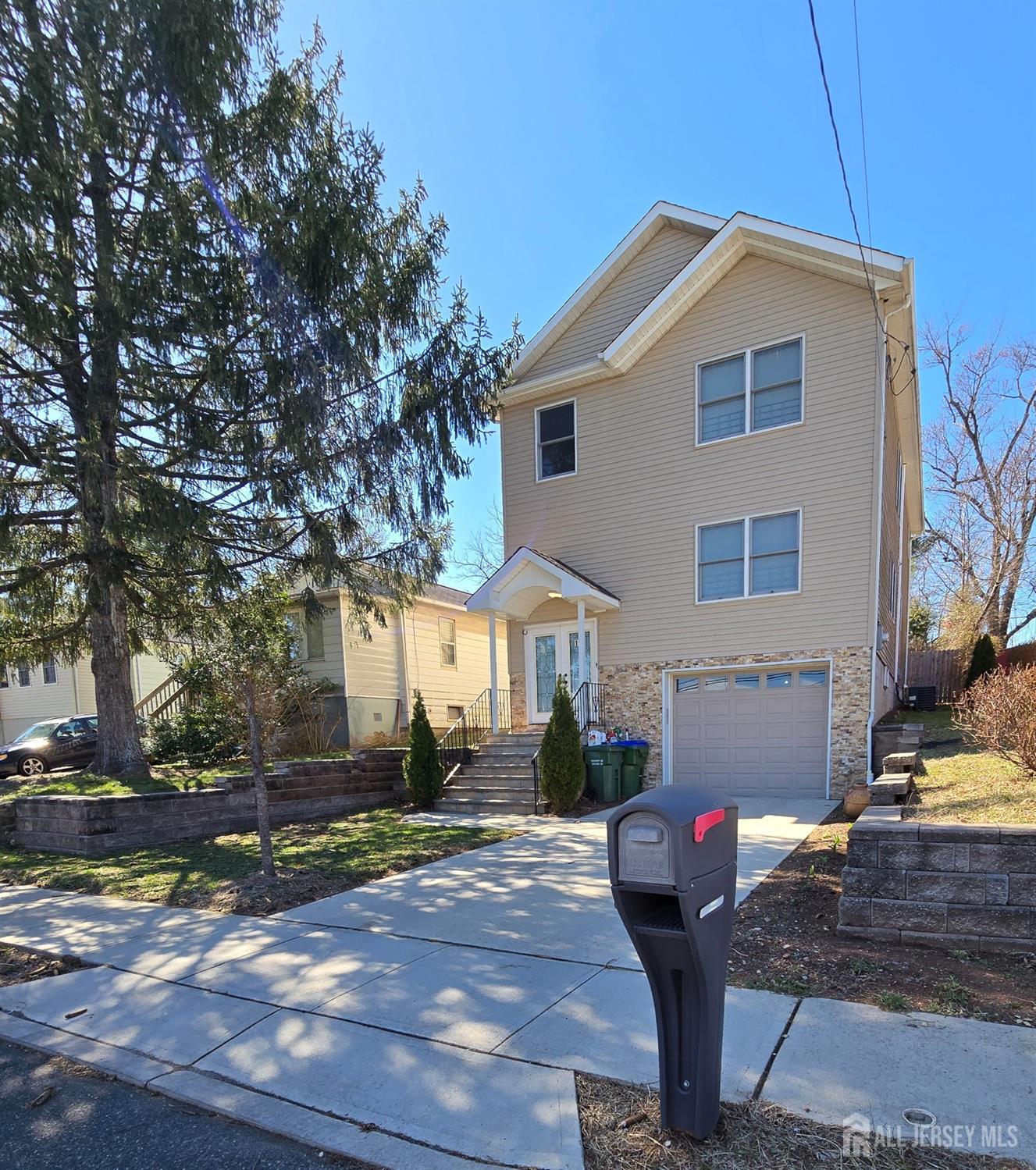 19 Henry Street Edison, NJ 08820 - Photo 3 of 33 a front view of a house with garden and parking
