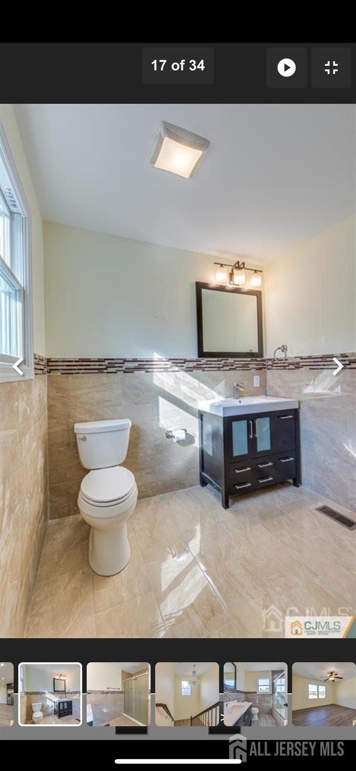 19 Henry Street Edison, NJ 08820 - Photo 33 of 33 a view of a kitchen with stainless steel appliances granite countertop a stove and a microwave