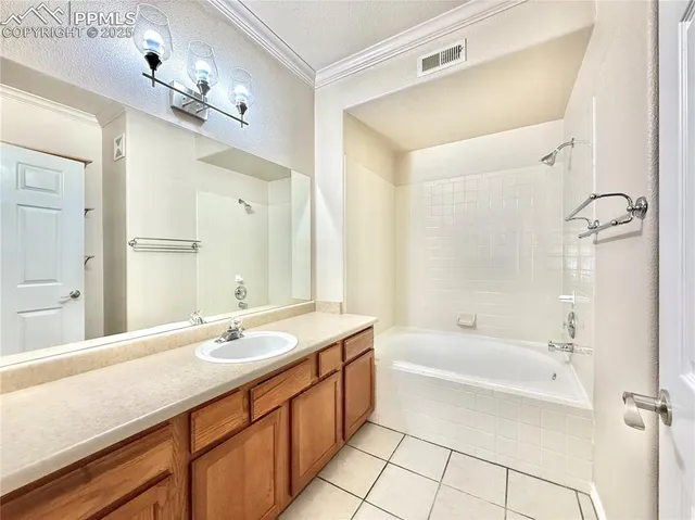 a bathroom with a tub a sink and mirror