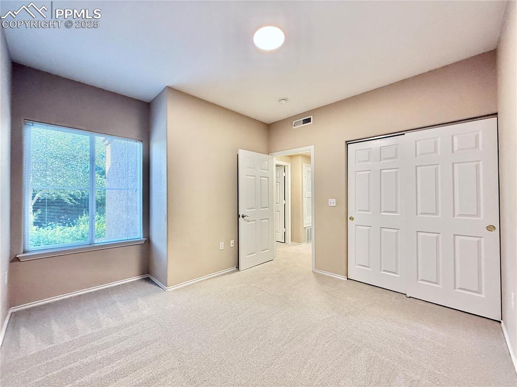 3764 Riviera Grove, Unit 103 Colorado Springs, CO 80922 - Photo 16 of 25 an empty room with windows and closet