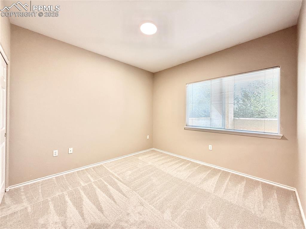 3764 Riviera Grove, Unit 103 Colorado Springs, CO 80922 - Photo 17 of 25 a view of an empty room with a window