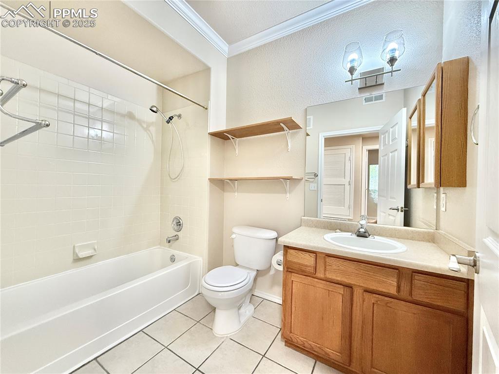 3764 Riviera Grove, Unit 103 Colorado Springs, CO 80922 - Photo 18 of 25 a bathroom with a sink a toilet and shower