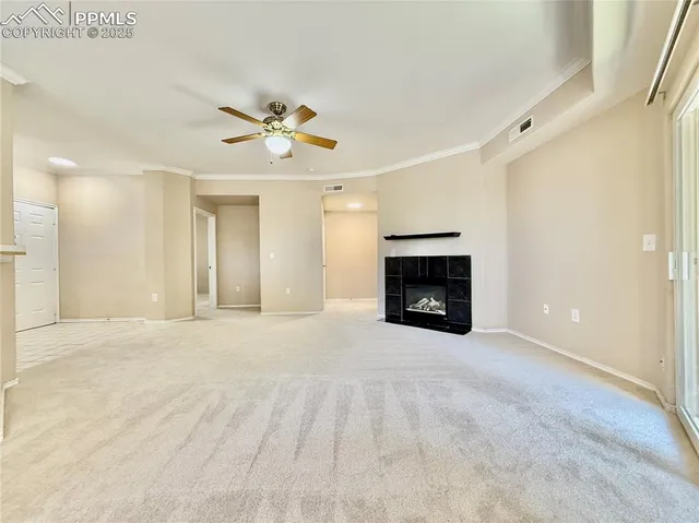a view of an empty room with a fireplace