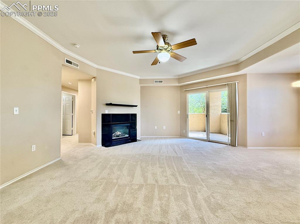 3764 Riviera Grove, Unit 103 Colorado Springs, CO 80922 - Photo 6 of 25 a view of an empty room with window and fireplace