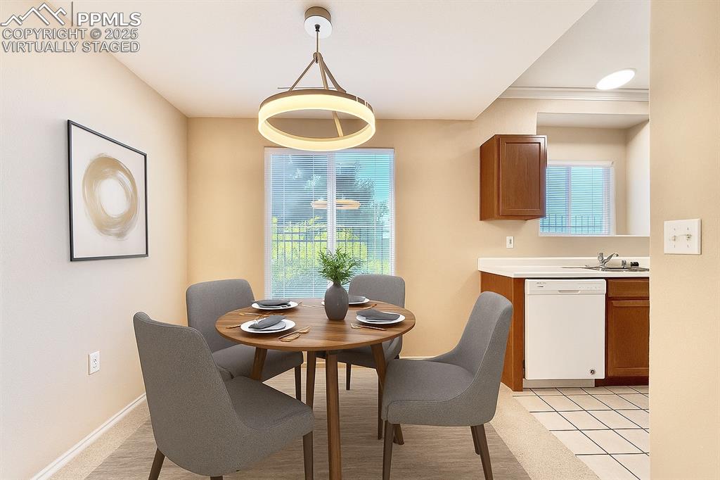 3764 Riviera Grove, Unit 103 Colorado Springs, CO 80922 - Photo 8 of 25 a view of a dining room with furniture and window