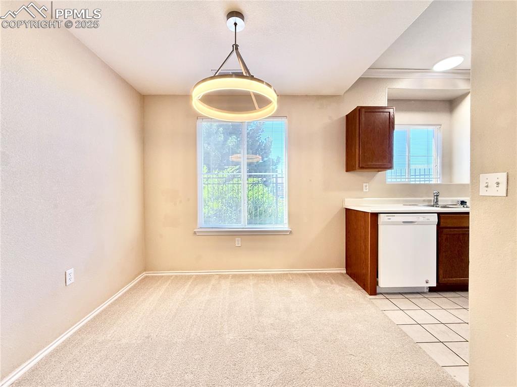 3764 Riviera Grove, Unit 103 Colorado Springs, CO 80922 - Photo 9 of 25 a view of a kitchen with a sink and window