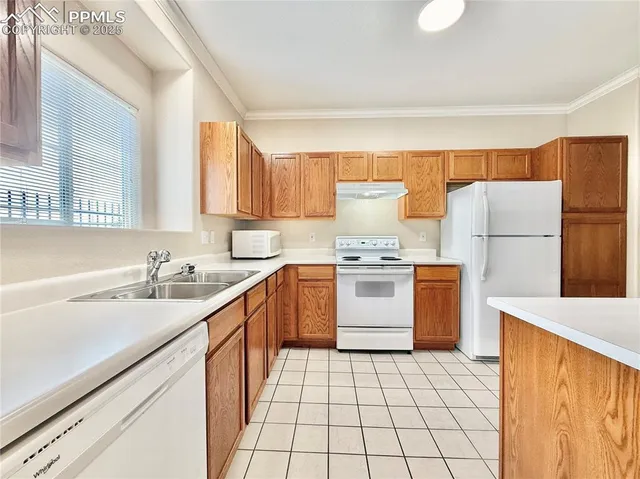 a kitchen with a sink a stove top oven a refrigerator and a sink