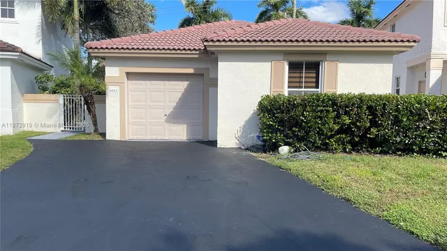 a kitchen with stainless steel appliances granite countertop a refrigerator a stove and a sink