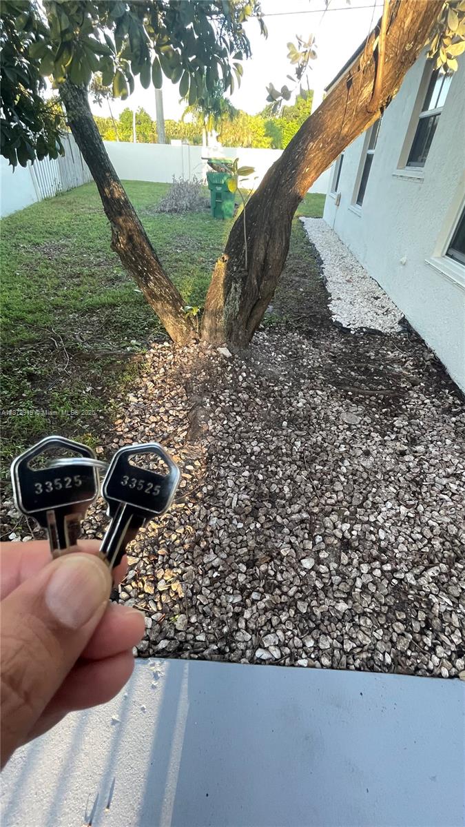 6952 Southwest 148 Lane Davie, FL 33331 - Photo 38 of 100 a backyard of a house with table and chairs