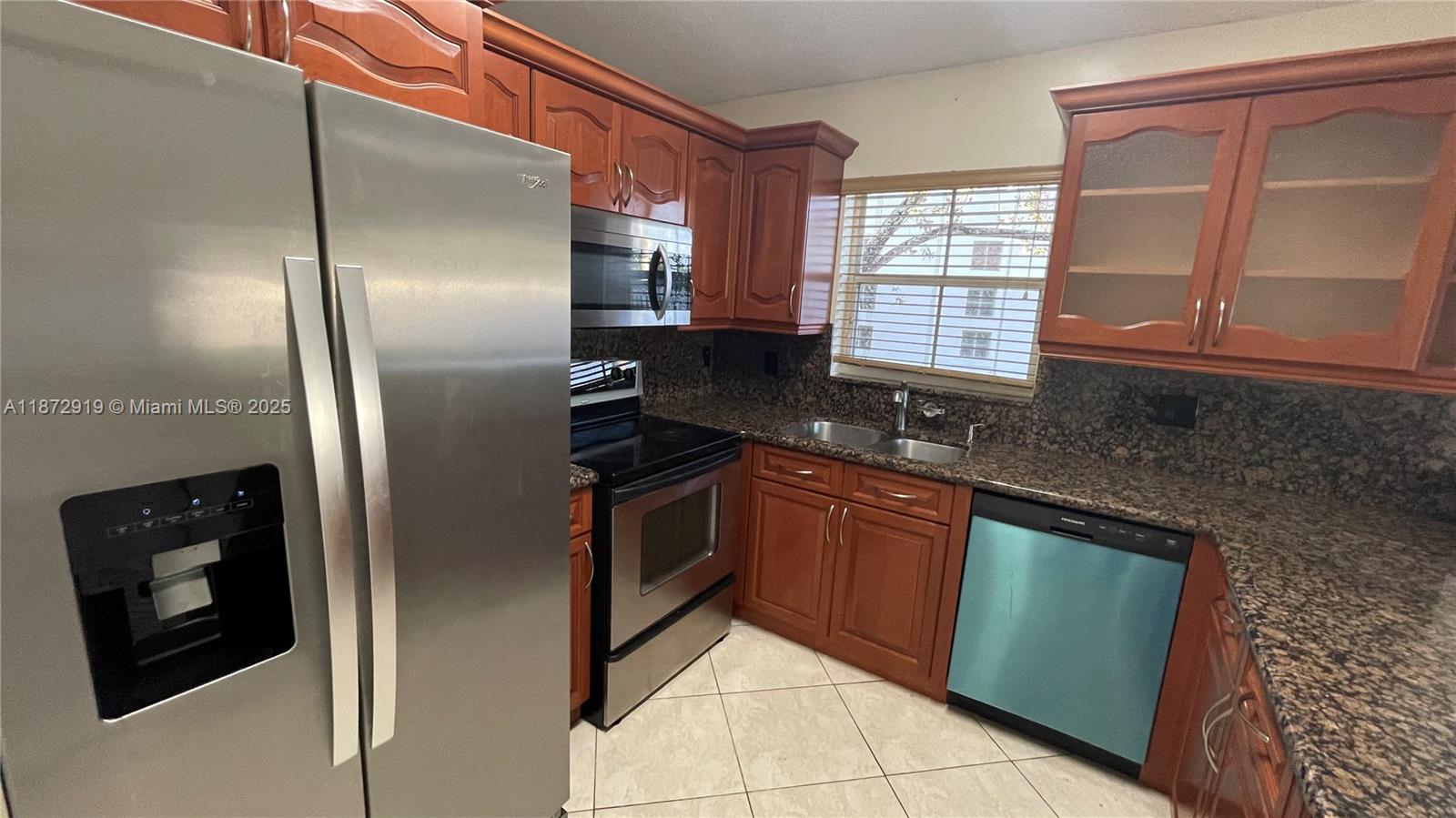 6952 Southwest 148 Lane Davie, FL 33331 - Photo 5 of 100 a kitchen with granite countertop stainless steel appliances a refrigerator microwave and sink