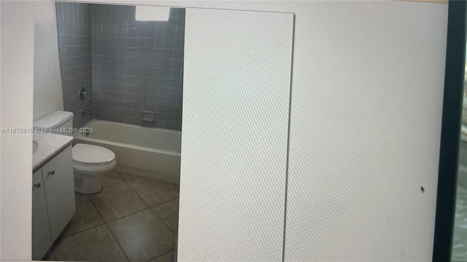 6952 Southwest 148 Lane Davie, FL 33331 - Photo 52 of 100 a bathroom with a granite countertop bathtub shower sink vanity and toilet