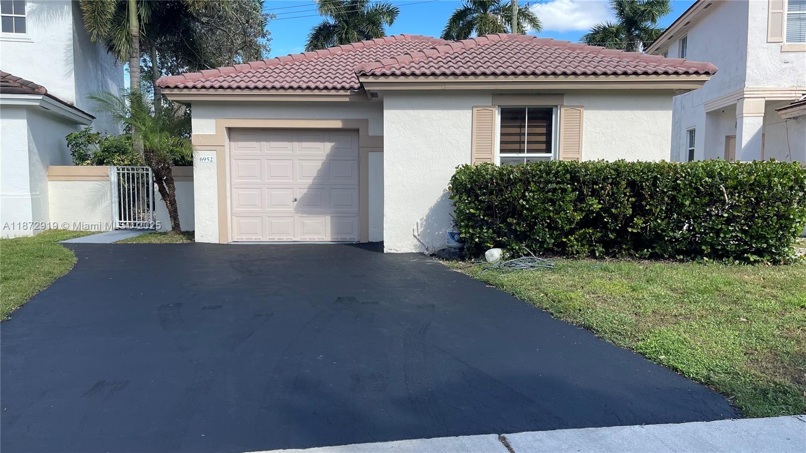 6952 Southwest 148 Lane Davie, FL 33331 - Photo 57 of 100 a front view of a house with a garden