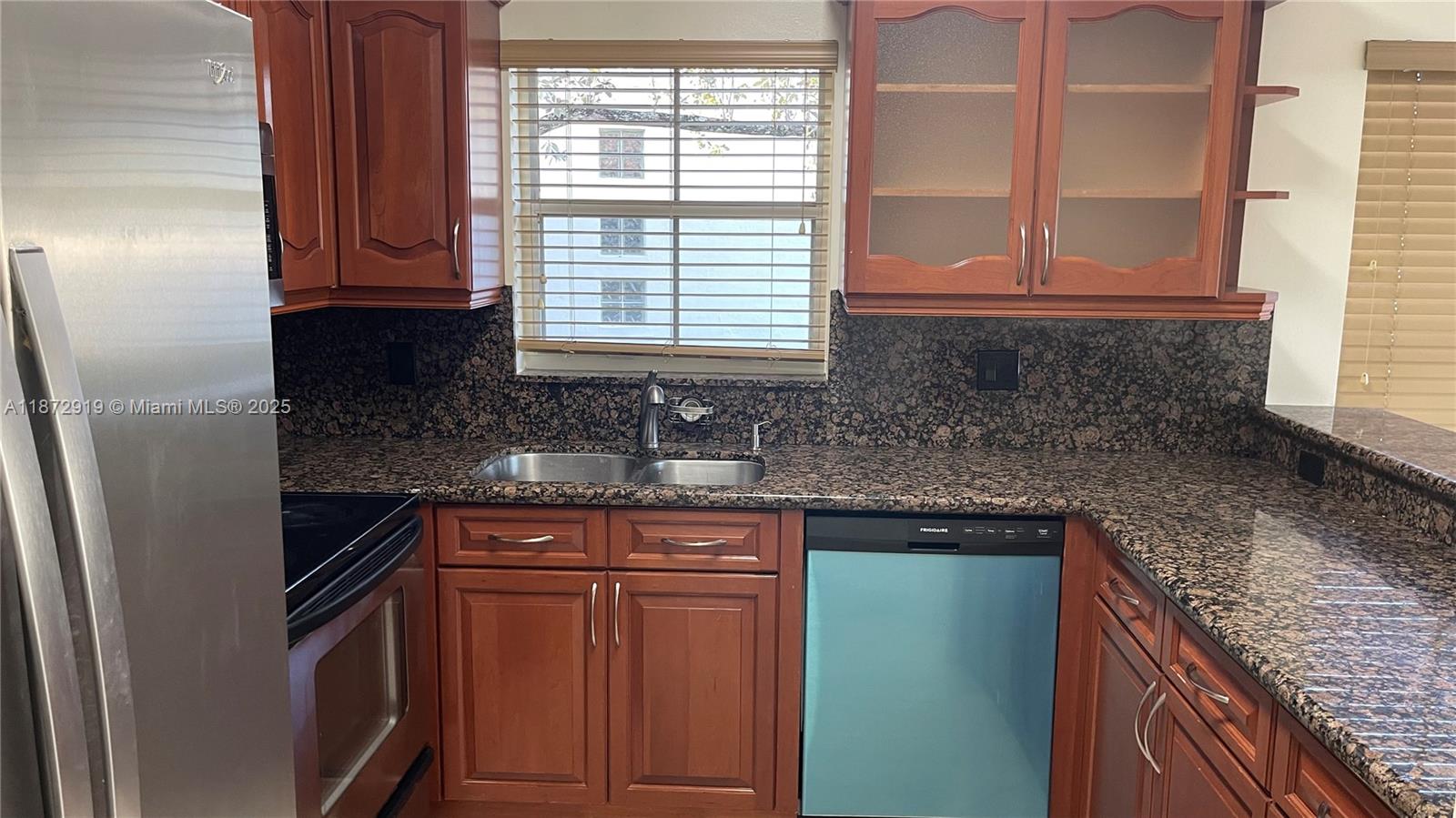 6952 Southwest 148 Lane Davie, FL 33331 - Photo 71 of 100 a kitchen with granite countertop cabinets stainless steel appliances a sink and a window