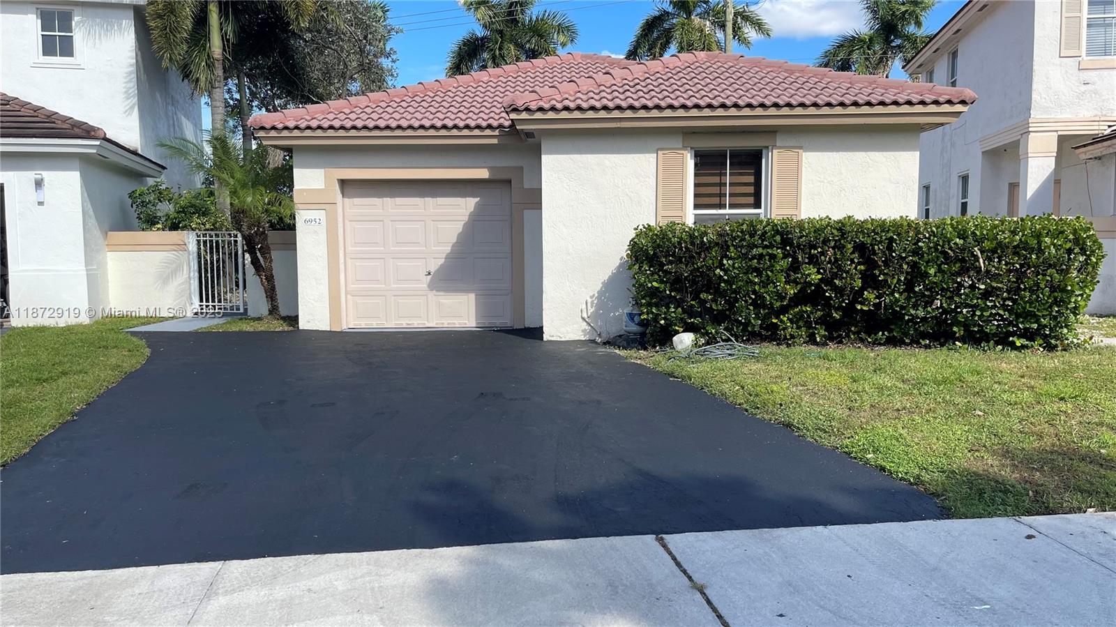 6952 Southwest 148 Lane Davie, FL 33331 - Photo 9 of 100 a front view of a house with a yard and garage
