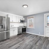 a kitchen with a refrigerator stove and wooden cabinets