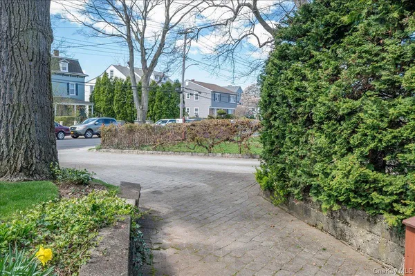 a view of a house with a yard and tree s