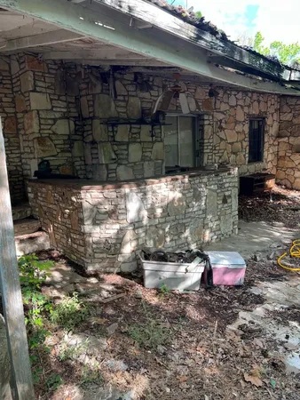 a backyard of a house with barbeque oven