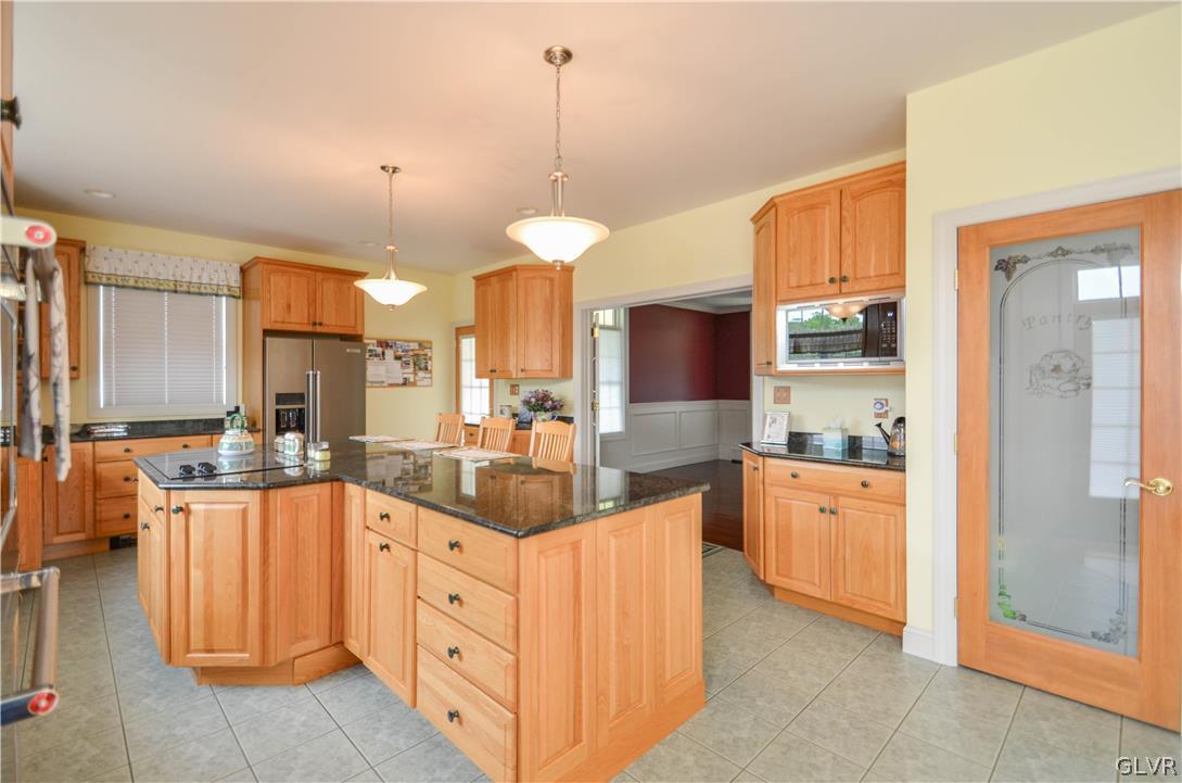 2359 Wehr Mill Road Allentown, PA 18104 - Photo 15 of 50 a large kitchen with white cabinets and chandelier