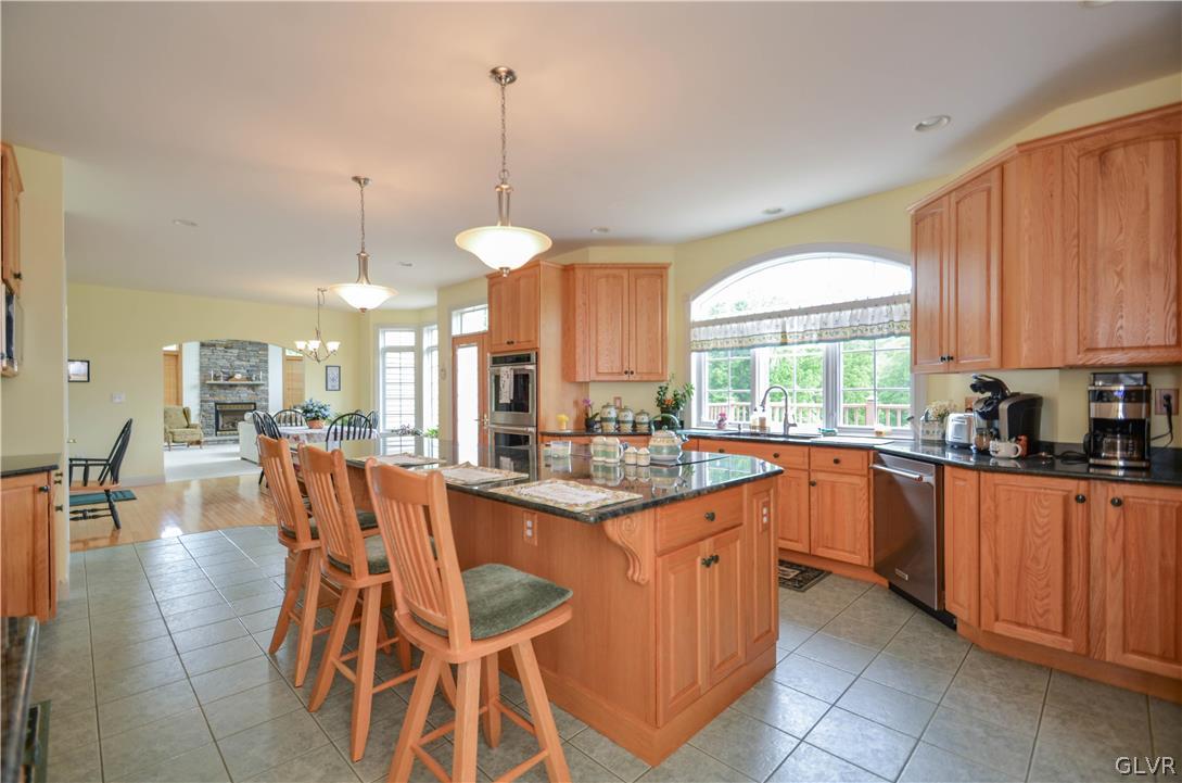 2359 Wehr Mill Road Allentown, PA 18104 - Photo 16 of 50 a kitchen with stainless steel appliances granite countertop wooden cabinets a dining table and chairs